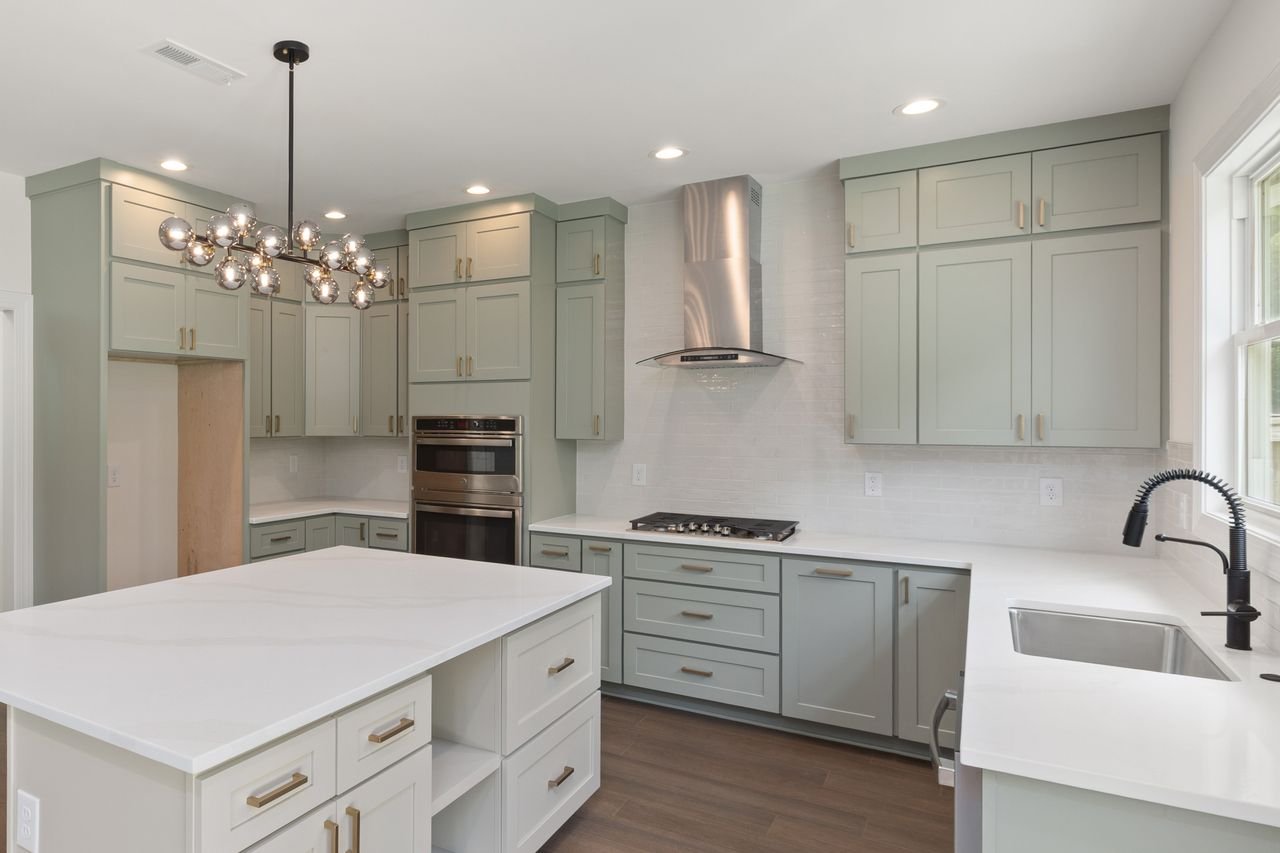 Services Bright modern kitchen featuring custom cabinets and stylish lighting, perfect for contemporary homes.